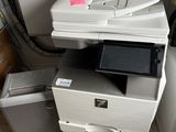 a printer sitting on top of a stack of boxes
