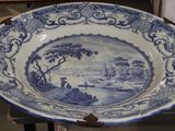 a large blue and white plate with a picture on it