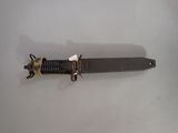 a knife that is laying on a white surface