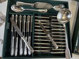 a tray with silverware and spoons in it on a table