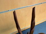 a wooden chair that is sitting in the middle of a room