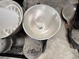 many bowls and pans sitting on the floor in a room
