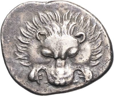 a close up of a silver coin with a lion head on it
