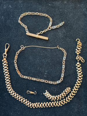 a collection of gold jewelry including a bracelet, bracelet, and necklace