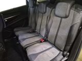 four seats in the back of a car with a red seat belt