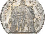 a silver coin with an image of a man and woman on it