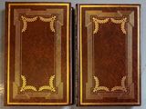pair of antique leather bound books with gold leaf decoration