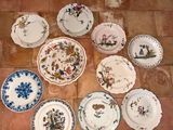 a lot of plates that are sitting on the floor