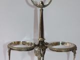 a silver plate with two bowls on it on a stand