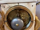 a clock that is sitting on a table with gold decorations