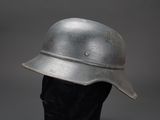 an old helmet on a mannequin head on a black mannequin