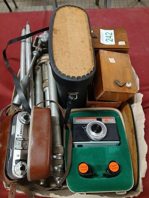 a box with a camera, a case, and other items on it