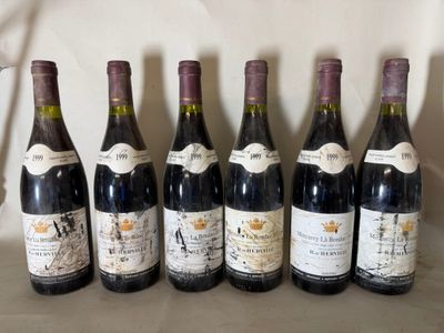 six bottles of wine are lined up in a row on a table