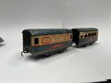 three toy trains sitting on a white surface next to each other