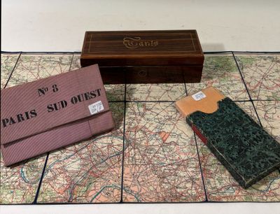 a map and a wallet on the floor next to a box