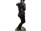statue of a woman holding a baseball bat on top of a wooden base