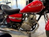 a red motorcycle that is parked in a showroom