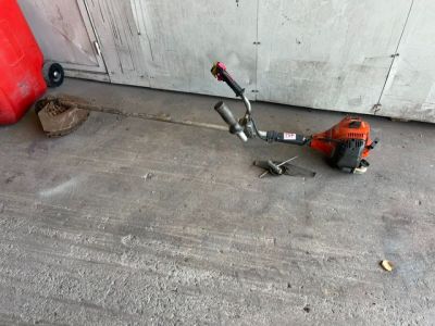 a scooter that is laying on the ground next to a fire hydrant
