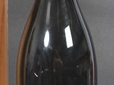 a bottle of wine sitting next to a wooden box