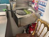 a chair that is next to a sink in a kitchen