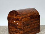 an old wooden box sitting on top of a floor next to a white wall