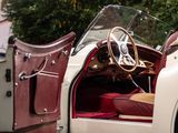a white car with a red seat and a steering