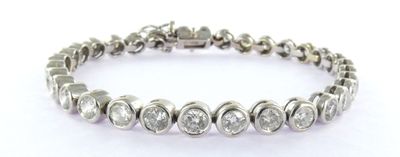 a close up of a diamond bracelet on a white background