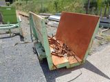 a rusted out dumpster sitting on the side of the road
