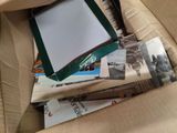 a box full of books and magazines on the couch