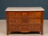 an antique chest of drawers with marble top and brass pulls