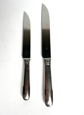 two knives that are sitting next to each other on a table