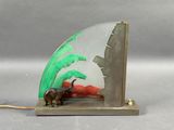a figurine of an elephant and a palm tree on a bookend