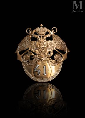 an image of a gold plated badge with an eagle on it