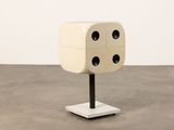 an image of a dice on a stand in the middle of a room