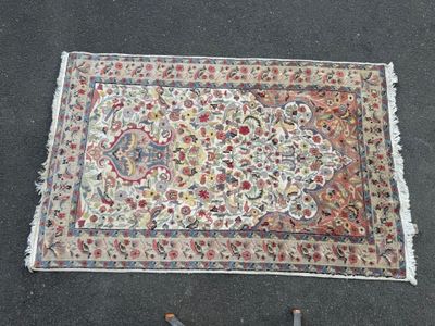 a rug on the ground next to a pair of scissors