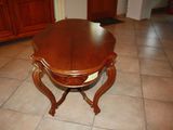 a table with a wooden top on a tiled floor