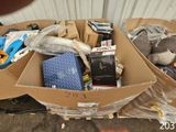 a cardboard box filled with assorted items on the ground