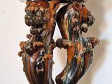 a wooden table that has a vase on top of it