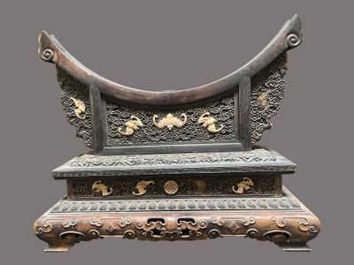a very ornate bench that is on display on a gray background