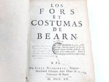 an old book with writing on it sitting on a table