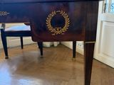 a small table with a wreath on it in a room