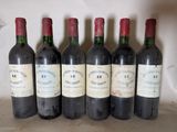 six bottles of wine are lined up in a row on a counter