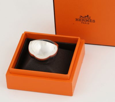 an orange box with a white bowl inside of it on a white surface