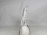 sculpture of a white bird sitting on top of a stone block