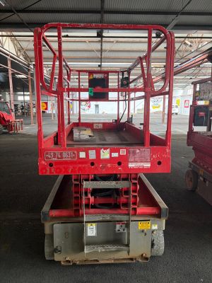 a picture of a red scissor sitting in a warehouse