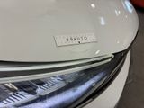 a close up of a car ' s headlight with a sticker on it