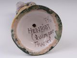 a close up of a small vase with writing on it