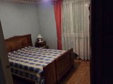 a bed in a room with a checkered comforter on it