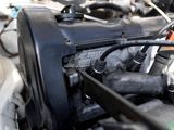 a close up view of a car engine with its hood open