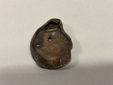 an old bronze coin with a face on it